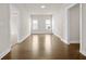 Hallway with hardwood floors between rooms with natural light from windows at 636 Silva St, Cumming, GA 30040