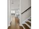 View of hallway with hardwood floors leading to a kitchen with pendant lighting at 636 Silva St, Cumming, GA 30040