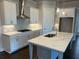 Modern kitchen showcasing a central island, gas cooktop, and state-of-the-art appliances at 636 Silva St, Cumming, GA 30040