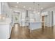 Modern kitchen with white cabinets, stainless steel appliances, kitchen island, and hardwood floors at 636 Silva St, Cumming, GA 30040