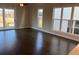 Open-concept living room with large windows, hardwood floors, and sliding door access to outdoor space at 636 Silva St, Cumming, GA 30040