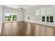 Spacious living room with hardwood floors, large windows, and sliding door access at 636 Silva St, Cumming, GA 30040