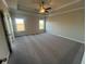 Spacious bedroom with large windows, carpet and tray ceiling with a ceiling fan at 636 Silva St, Cumming, GA 30040