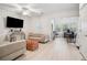 Bright, neutral living room with wood floors, a ceiling fan, and ample natural light at 1186 Arbor Park Sw Ln, Atlanta, GA 30311