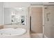 Main bathroom showcasing a large soaking tub and walk in shower with neutral tile at 1186 Arbor Park Sw Ln, Atlanta, GA 30311