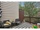 Cozy outdoor patio area with comfortable seating, decorative rug, and privacy fence for relaxation at 1186 Arbor Park Sw Ln, Atlanta, GA 30311
