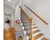 Elegant staircase with wooden rails, white risers and decorative black metal spindles at 1186 Arbor Park Sw Ln, Atlanta, GA 30311