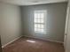 Cozy bedroom with neutral walls, plush carpet, and ample natural light creating a peaceful retreat at 2039 Corners Cir, Lithonia, GA 30058