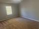 This bedroom features neutral paint, a plush carpet, and a window that provides natural light at 2039 Corners Cir, Lithonia, GA 30058