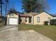 Charming single-story home with a driveway and attached garage at 2039 Corners Cir, Lithonia, GA 30058