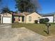 Charming single-story home with well-manicured lawn and attached garage and a driveway in a suburban neighborhood at 2039 Corners Cir, Lithonia, GA 30058