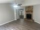 Inviting living room featuring a stone fireplace, ceiling fan, and stylish flooring, perfect for relaxation at 2039 Corners Cir, Lithonia, GA 30058