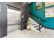 Hallway featuring elevator, staircase and accent wall with modern art at 22 Airline Ne St # 204, Atlanta, GA 30312
