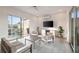 Bright living room with comfortable seating, balcony access, and a modern entertainment center at 22 Airline Ne St # 204, Atlanta, GA 30312