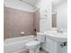 Neutral bathroom features a shower and tub combination, large-format tile, and a classic pedestal sink at 250 Pharr Ne Rd # 2101, Atlanta, GA 30305
