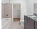 Bathroom with tub, granite vanity, neutral tile, and walk-in closet access at 250 Pharr Ne Rd # 2101, Atlanta, GA 30305