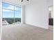Empty bedroom with carpet and floor-to-ceiling windows showcasing a city view at 250 Pharr Ne Rd # 2101, Atlanta, GA 30305