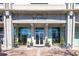 Modern building entrance with manicured greenery and clear glass doors showcasing a welcoming interior at 250 Pharr Ne Rd # 2101, Atlanta, GA 30305