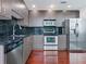Modern kitchen with stainless steel appliances, dark cabinets, and a black backsplash at 250 Pharr Ne Rd # 2101, Atlanta, GA 30305
