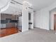 Open kitchen layout with stainless steel appliances, gray cabinetry, and an adjacent carpeted living area at 250 Pharr Ne Rd # 2101, Atlanta, GA 30305