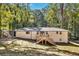 Charming home featuring a backyard deck surrounded by mature trees, offering privacy and serene outdoor living at 2615 Holly Ln, Marietta, GA 30062
