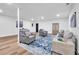 Basement with a blue and white area rug, neutral couches, and a white support beam in the center of the room at 2615 Holly Ln, Marietta, GA 30062