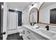 Bathroom featuring a tub with shower with black hardware and a double vanity at 2615 Holly Ln, Marietta, GA 30062