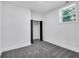 Bedroom with carpet, white walls, window, and closet with black door frame at 2615 Holly Ln, Marietta, GA 30062