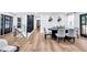 Open concept dining room with modern light gray chairs, black accents, and hardwood floors at 2615 Holly Ln, Marietta, GA 30062