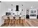 Bright modern kitchen featuring a wooden island, stylish chairs, and sleek, black accents at 2615 Holly Ln, Marietta, GA 30062