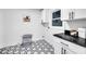 Bright laundry room with geometric tile floors, cabinet, and laundry basket at 2615 Holly Ln, Marietta, GA 30062