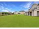 Extensive lawn in backyard with covered patio, ideal for outdoor activities and entertaining at 4720 Gablestone Xing, Hoschton, GA 30548