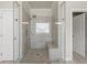 Modern shower featuring tiled surround and glass door at 4720 Gablestone Xing, Hoschton, GA 30548