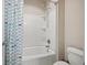 Cozy bathroom with a fish-themed shower curtain over a tub and a toilet, perfect for a bath at 4720 Gablestone Xing, Hoschton, GA 30548