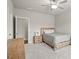 Bright bedroom with a bed, two nightstands, and a dresser, creating a cozy and inviting atmosphere at 4720 Gablestone Xing, Hoschton, GA 30548