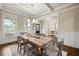 Elegant dining room boasting a coffered ceiling, wainscoting, and abundant natural light at 4720 Gablestone Xing, Hoschton, GA 30548