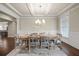 Bright dining room features coffered ceilings, wainscoting, and a decorative chandelier over the dining table at 4720 Gablestone Xing, Hoschton, GA 30548