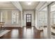 Elegant entryway featuring hardwood floors, detailed trim work, and abundant natural light at 4720 Gablestone Xing, Hoschton, GA 30548