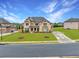 Beautiful two-story home with brick and stone, an expansive yard, and a long driveway at 4720 Gablestone Xing, Hoschton, GA 30548