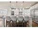 Bright kitchen with island and bar stool seating, stainless steel appliances, and white cabinetry at 4720 Gablestone Xing, Hoschton, GA 30548