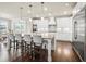 Bright kitchen with an island, stainless steel appliances, white cabinets, and pendant lighting at 4720 Gablestone Xing, Hoschton, GA 30548
