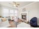 Inviting living room featuring a stone fireplace, natural light, and cozy decor at 4720 Gablestone Xing, Hoschton, GA 30548