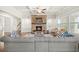 Cozy living room with stone fireplace, coffered ceilings, and a comfortable gray sofa with blue pillows at 4720 Gablestone Xing, Hoschton, GA 30548
