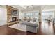 Open-concept living room features a stone fireplace, coffered ceilings, and a comfortable sofa at 4720 Gablestone Xing, Hoschton, GA 30548