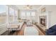 Inviting living room with a stone fireplace, large windows, and comfortable seating at 4720 Gablestone Xing, Hoschton, GA 30548