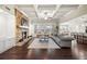 Spacious living room showcases a stone fireplace, coffered ceilings, and a cozy gray sofa at 4720 Gablestone Xing, Hoschton, GA 30548