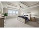 Lovely main bedroom with tray ceiling, carpet and light-filled windows at 4720 Gablestone Xing, Hoschton, GA 30548