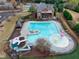 Aerial view of a community pool with slides, play features, and an adjacent home at 4720 Gablestone Xing, Hoschton, GA 30548