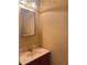 Cozy powder room featuring a sleek vanity and well-lit mirror for convenience at 4006 Bayside Cir, Atlanta, GA 30340