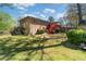 Brick home exterior with a deck overlooking the spacious, green backyard at 4892 Duncan Dr, Powder Springs, GA 30127